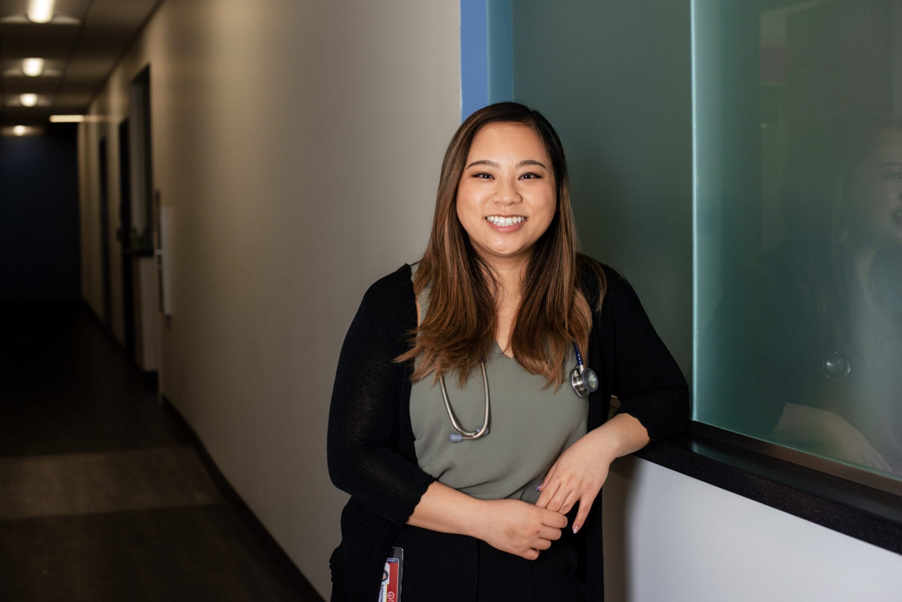 Asian female standing, smiling. Head shot.